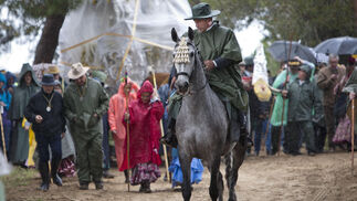 Los peregrinos, equipados para la lluvia, cruzando hacia el Coto en la romería del año pasado.